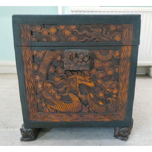 239 - A 20thC Chinese camphorwood blanket chest, profusely carved with dragons and clouds, having straight... 