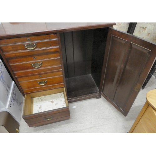 240 - An Edwardian gentleman's mahogany chest, comprising a bank of four offset drawers, beside a panelled... 