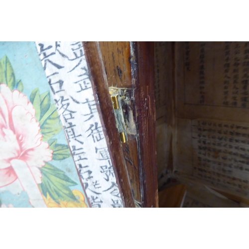 241 - A 20thC Korean brass bound fruitwood chest with an arrangement of cupboard doors and drawers, in two... 