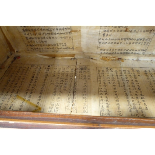 241 - A 20thC Korean brass bound fruitwood chest with an arrangement of cupboard doors and drawers, in two... 