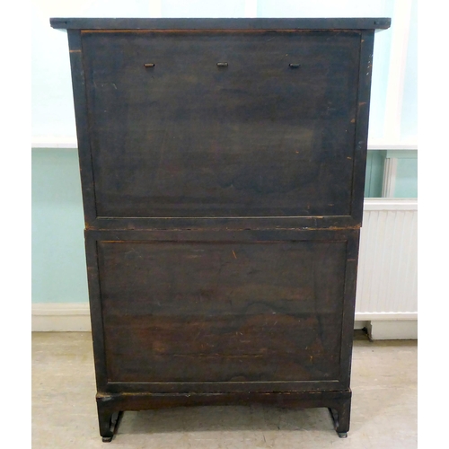 241 - A 20thC Korean brass bound fruitwood chest with an arrangement of cupboard doors and drawers, in two... 