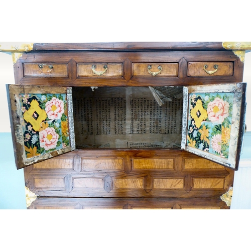 241 - A 20thC Korean brass bound fruitwood chest with an arrangement of cupboard doors and drawers, in two... 