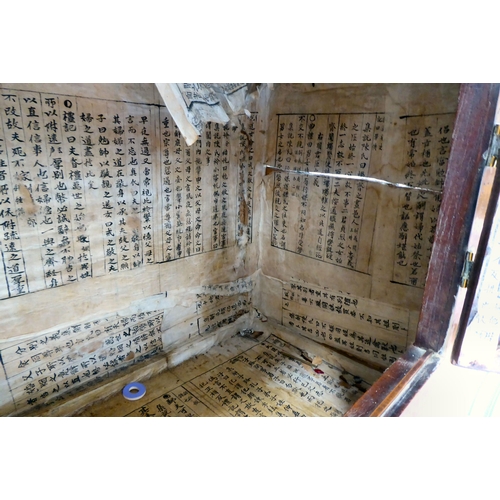 241 - A 20thC Korean brass bound fruitwood chest with an arrangement of cupboard doors and drawers, in two... 