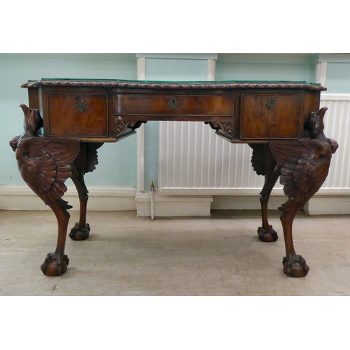 299 - An Edwardian mahogany concave front desk, the top with a gadroon moulded edge, over three drawers, r... 