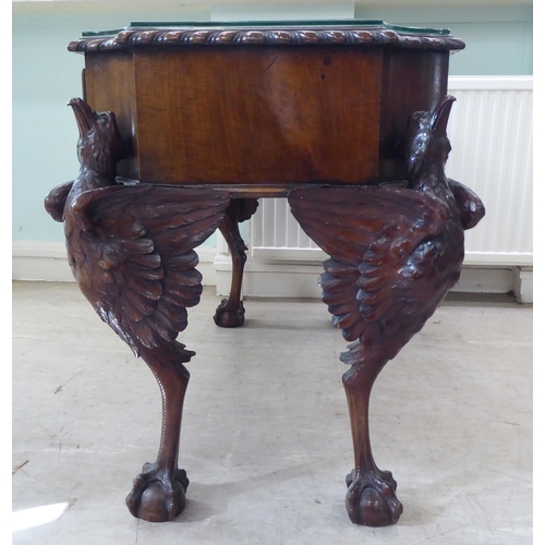 299 - An Edwardian mahogany concave front desk, the top with a gadroon moulded edge, over three drawers, r... 