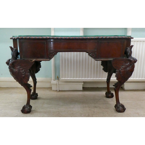 299 - An Edwardian mahogany concave front desk, the top with a gadroon moulded edge, over three drawers, r... 