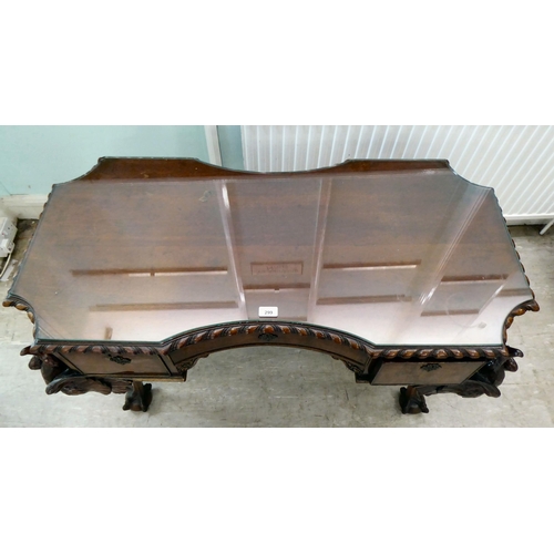 299 - An Edwardian mahogany concave front desk, the top with a gadroon moulded edge, over three drawers, r... 