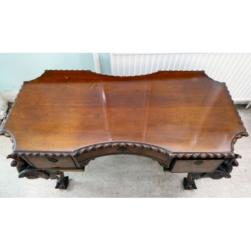 299 - An Edwardian mahogany concave front desk, the top with a gadroon moulded edge, over three drawers, r... 