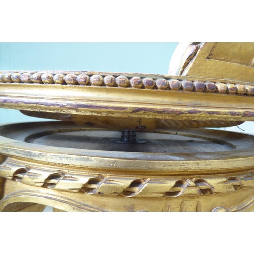 302 - A late 19thC French giltwood, revolving dressing table chair with a caned back and seat, raised on c... 