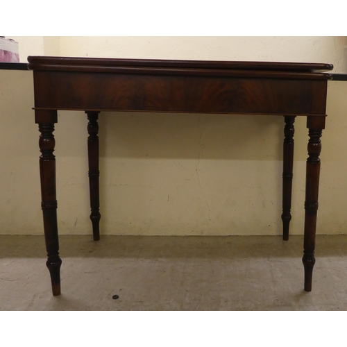 104 - A 19thC mahogany tea table, the foldover top raised on ring turned legs  29