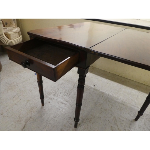 104 - A 19thC mahogany tea table, the foldover top raised on ring turned legs  29