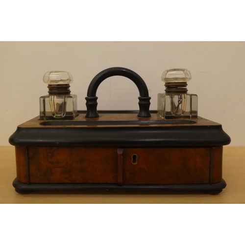 122 - A mid Victorian walnut finished inkwell deskstand with two pen reservoirs, over a hinged door  ... 