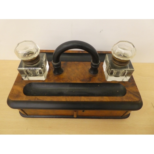 122 - A mid Victorian walnut finished inkwell deskstand with two pen reservoirs, over a hinged door  ... 