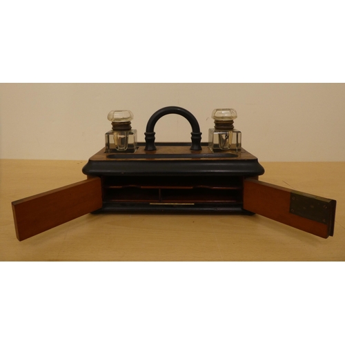 122 - A mid Victorian walnut finished inkwell deskstand with two pen reservoirs, over a hinged door  ... 