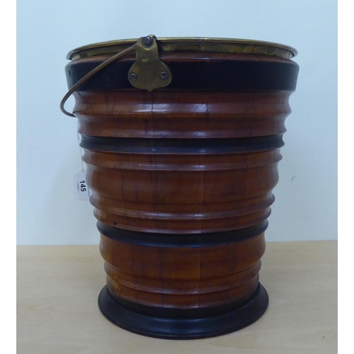 145 - A mid 20thC treen bucket of ribbed, tapered form with an associated brass liner  13