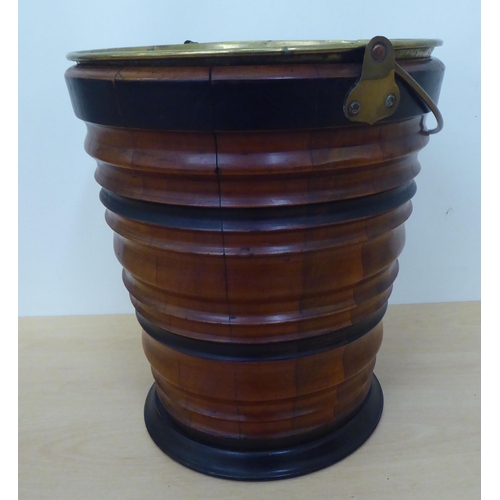 145 - A mid 20thC treen bucket of ribbed, tapered form with an associated brass liner  13