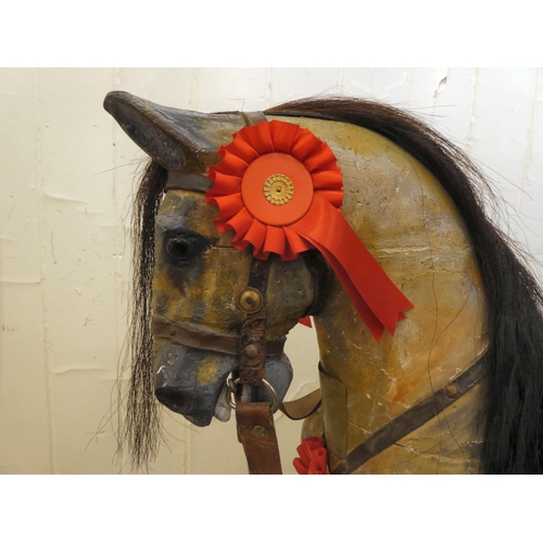 147 - An early 20thC carved and overpainted nursery rocking horse, on a plinth plinth  39