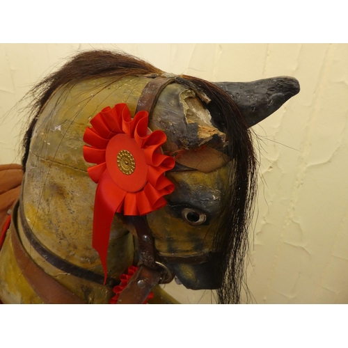 147 - An early 20thC carved and overpainted nursery rocking horse, on a plinth plinth  39