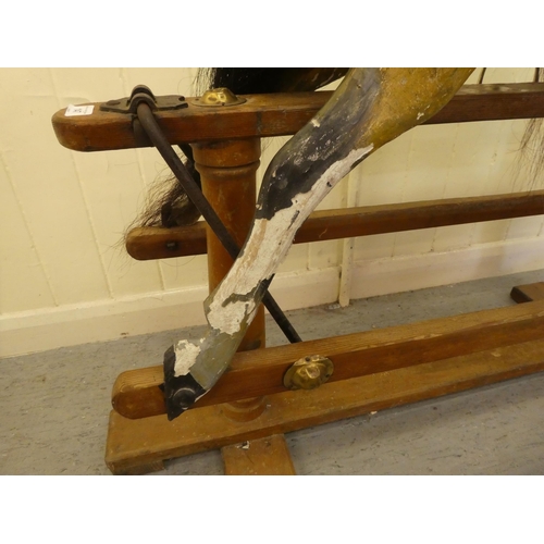 147 - An early 20thC carved and overpainted nursery rocking horse, on a plinth plinth  39