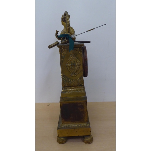 150 - An early 20thC French gilt metal cased mantel clock with a figure and harp; the Venault of Paris mov... 