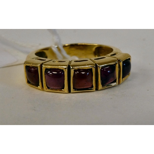 165 - A yellow metal (possibly 18ct) ring, set with five garnets  