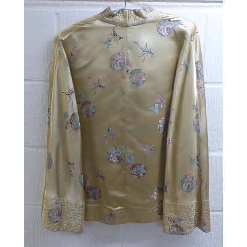 173 - A Chinese silk jacket, embroidered with dragons and flowers  size small