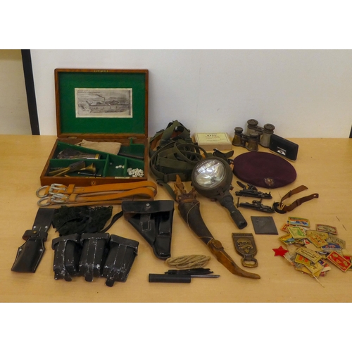 176 - Military collectables: to include a cast metal shot flask(Please Note: this lot is subject to the st... 