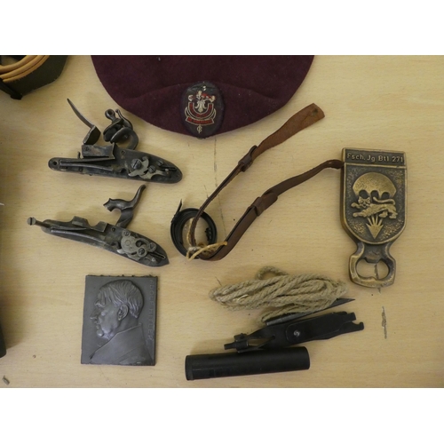 176 - Military collectables: to include a cast metal shot flask(Please Note: this lot is subject to the st... 