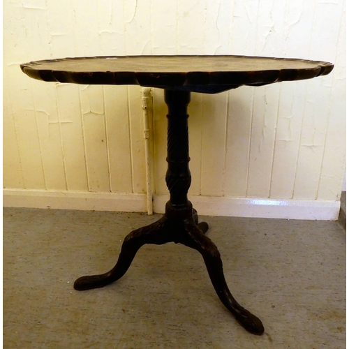 177 - A George III mahogany pedestal, the top with a piecrust edge, over a spiral reeded column and a trip... 