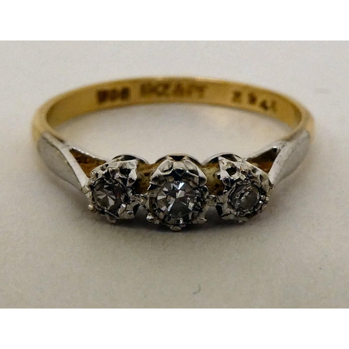 191 - An 18ct gold three stone diamond ring