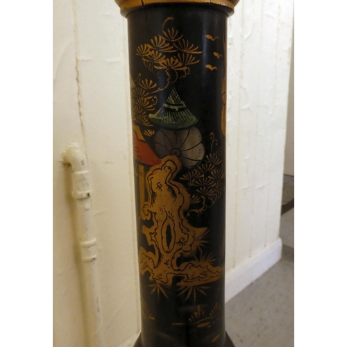 196 - A mid 20thC Oriental black and gilt painted standard lamp, decorated in traditional taste with figur... 