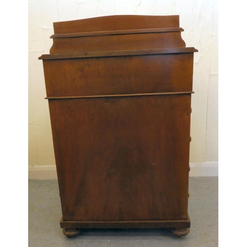 197 - An Edwardian walnut and mahogany Davenport with a hinged top and a galleried compartment, over a ban... 