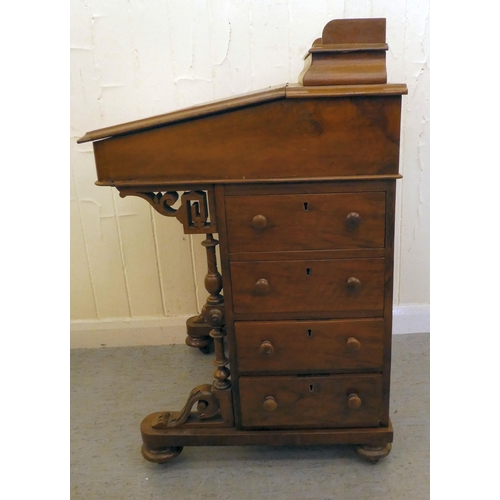 197 - An Edwardian walnut and mahogany Davenport with a hinged top and a galleried compartment, over a ban... 