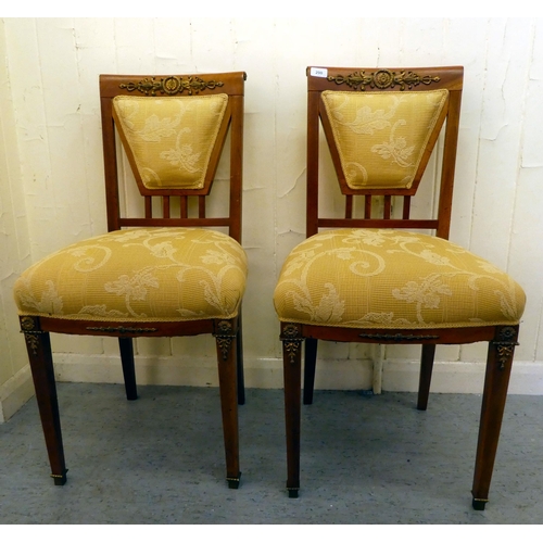 200 - A pair of late 19thC style Continental inspired mahogany and gilt metal mounted hall chairs 