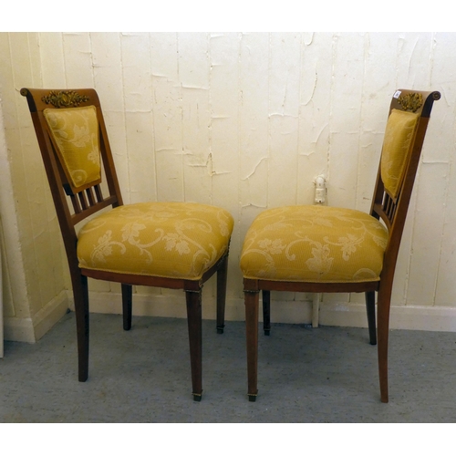 200 - A pair of late 19thC style Continental inspired mahogany and gilt metal mounted hall chairs 