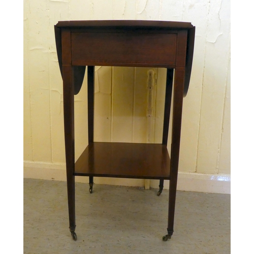 201 - An Edwardian mahogany drop leaf, two tier occasional table, raised on square legs and casters  ... 