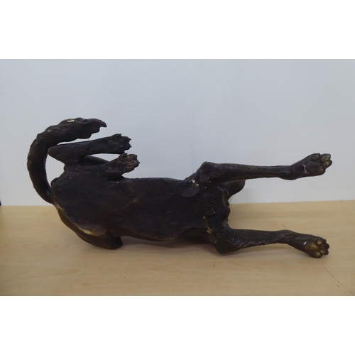 202 - A 20thC cast bronze model, a recumbent hound  11