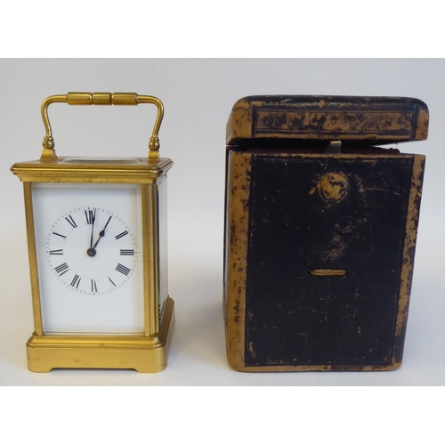 203 - A 20thC brass and glazed cased carriage clock; the movement faced by a Roman dial  5