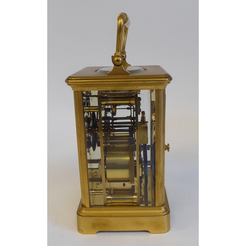 203 - A 20thC brass and glazed cased carriage clock; the movement faced by a Roman dial  5