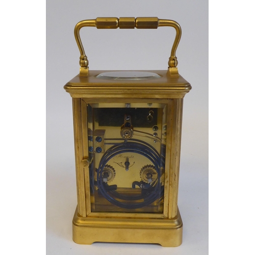 203 - A 20thC brass and glazed cased carriage clock; the movement faced by a Roman dial  5