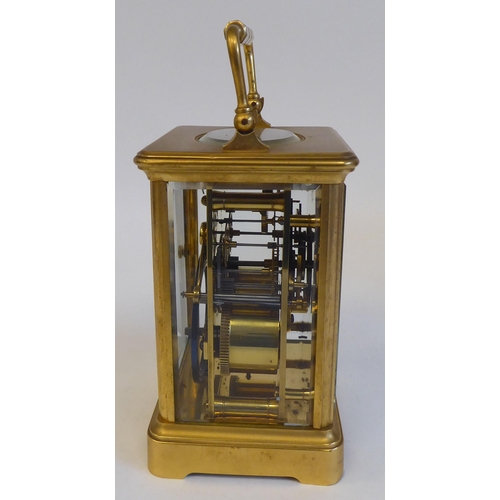 203 - A 20thC brass and glazed cased carriage clock; the movement faced by a Roman dial  5