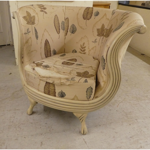 21 - A modern cream painted showwood framed nursery reading/feeding chair, raised on tapered legs