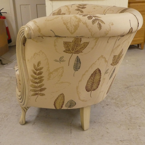 21 - A modern cream painted showwood framed nursery reading/feeding chair, raised on tapered legs