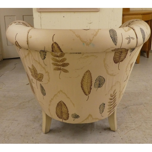 21 - A modern cream painted showwood framed nursery reading/feeding chair, raised on tapered legs