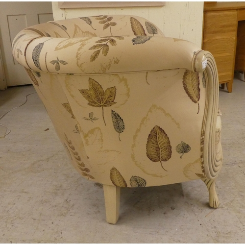 21 - A modern cream painted showwood framed nursery reading/feeding chair, raised on tapered legs