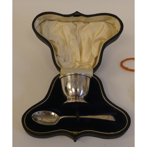 213 - A mixed lot: to include a silver Christening egg cup and spoon; costume jewellery and collectables&n... 