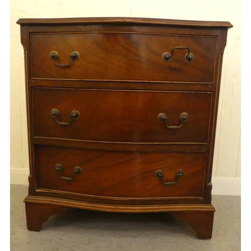 255 - An early/mid 20thC crossbanded mahogany serpentine front three drawer bedside chest, raised on brack... 