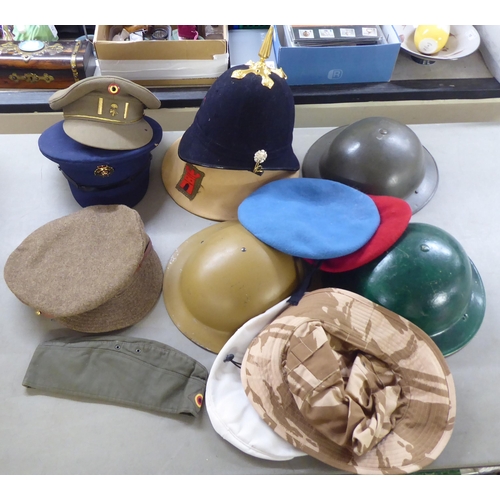 266 - Military hats and caps, mostly replicas: to include a tin helmet(Please Note: this lot is subject to... 