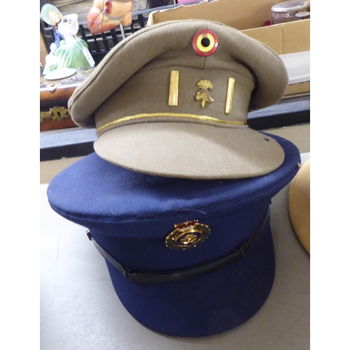 266 - Military hats and caps, mostly replicas: to include a tin helmet(Please Note: this lot is subject to... 