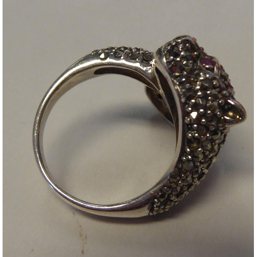 285 - A silver coloured metal and marcasite Panther style ring with ruby set eyes